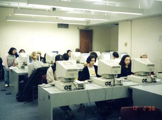 An old picture of women at box computers.