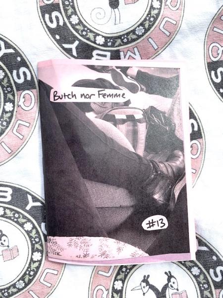 photo of zine on Quimby's bookstore background. zine cover is a photo of the creator's pants clad left leg, folded. 