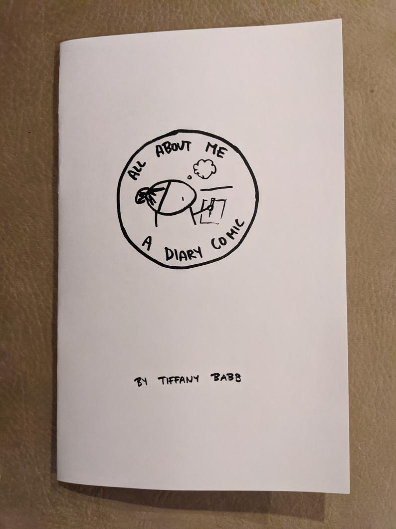photo of zine: title and stick figure self-portrait in a circle
