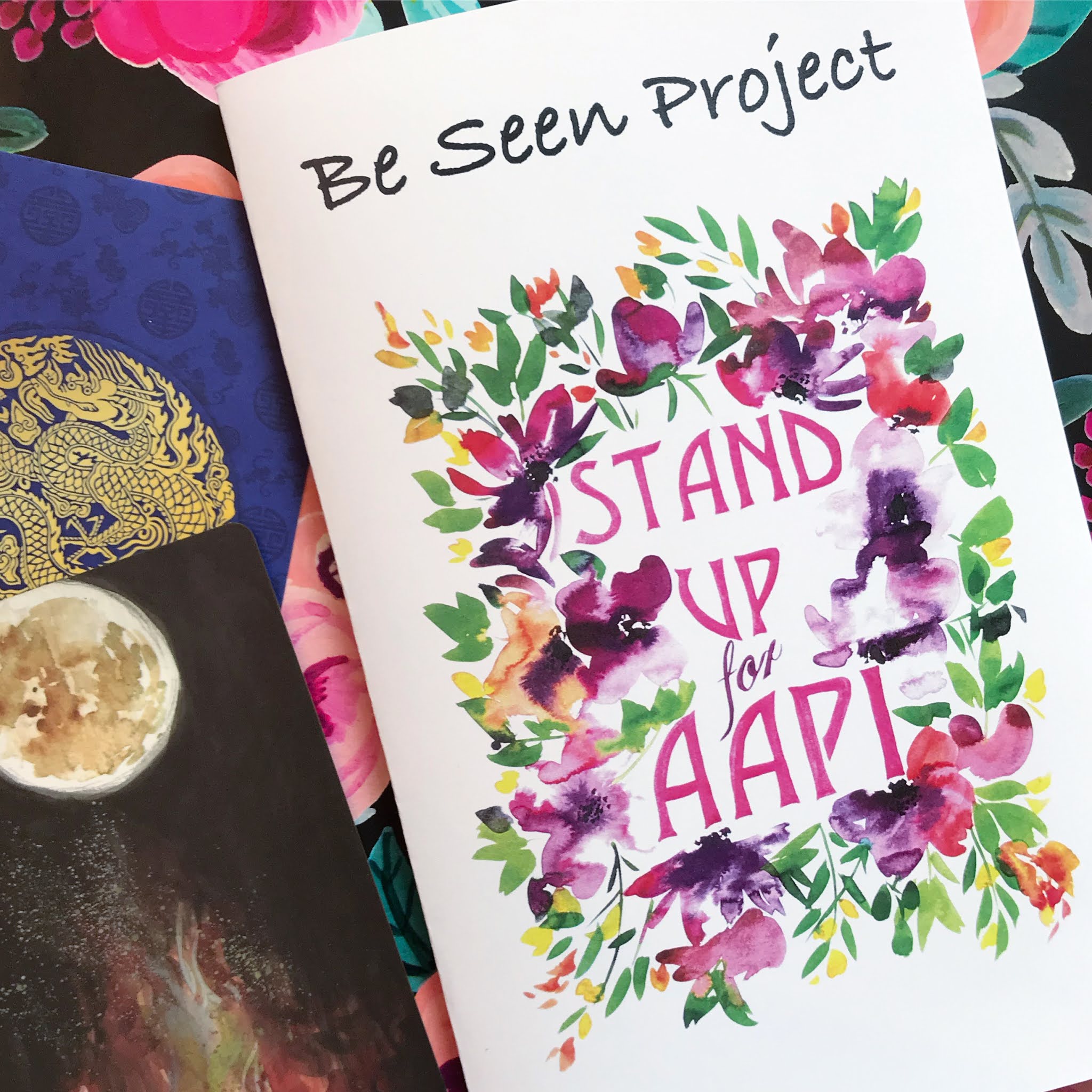 photo of zine (cover title appears to be Stand Up for AAPI): color; title in wreath of flowers