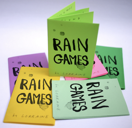 photo of zines in different colors. Title in all caps, simulated raindrop stains.