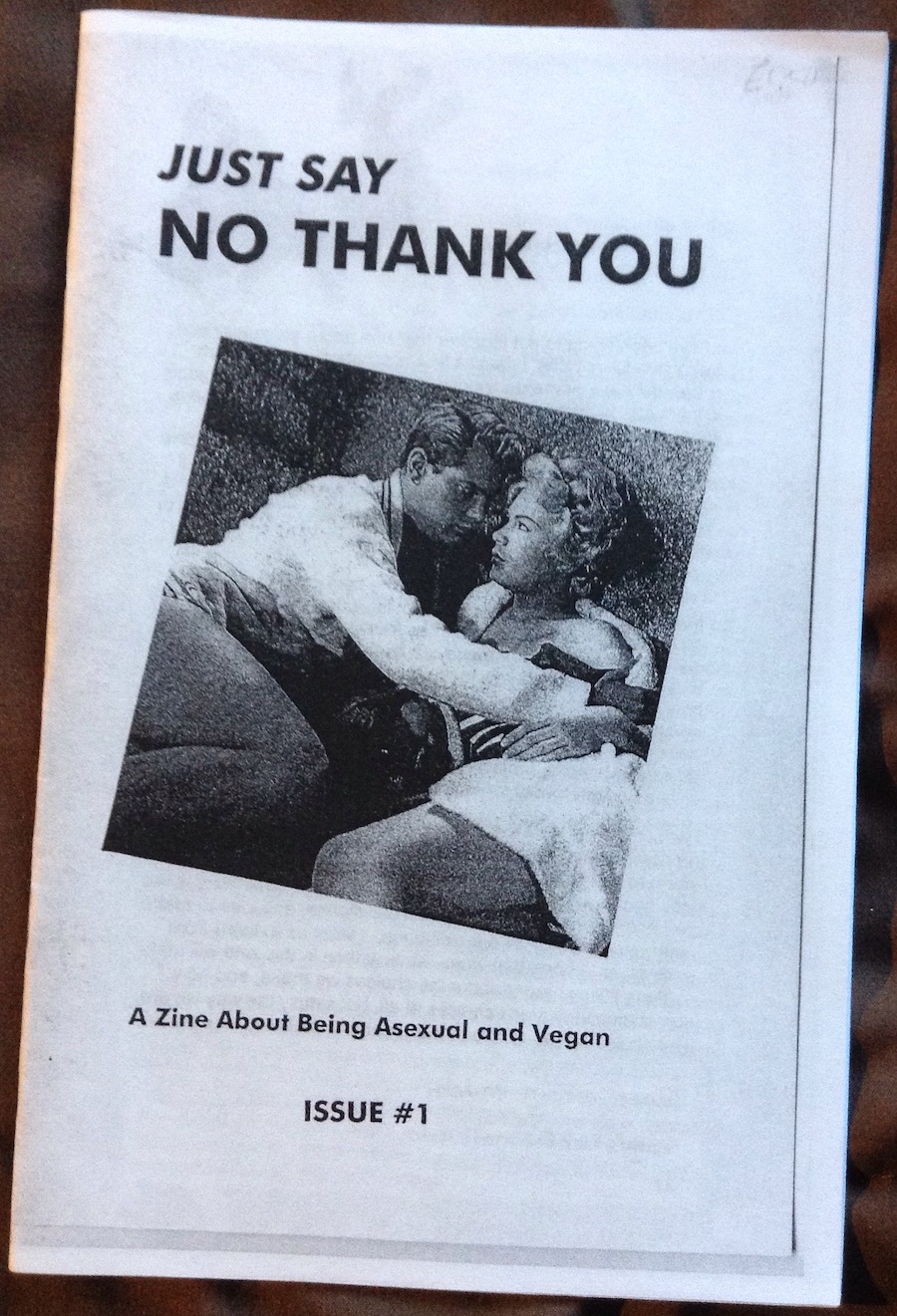 photo of a zine cover: 1950s looking heterosexual couple--man making a move on a woman pushing him away