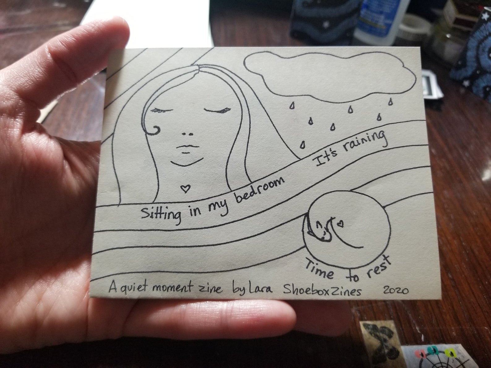 zine cover: Survived Today. Drawing of a person with long hair. 