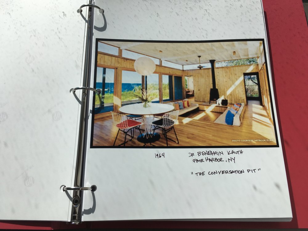 Photo of Fire Island home's interior inside a three ring binder.
