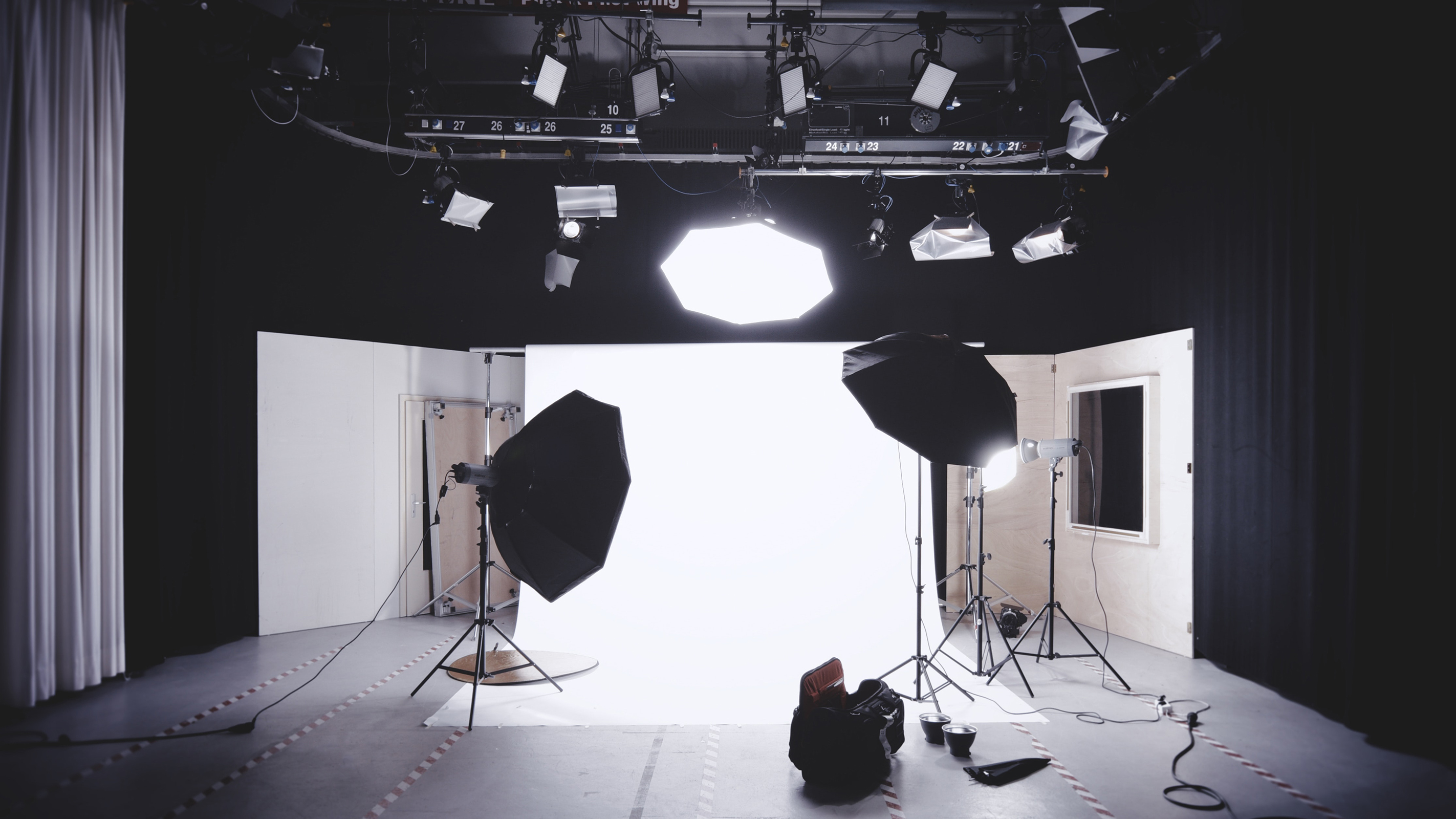 Bright softbox lights aimed at a white backdrop