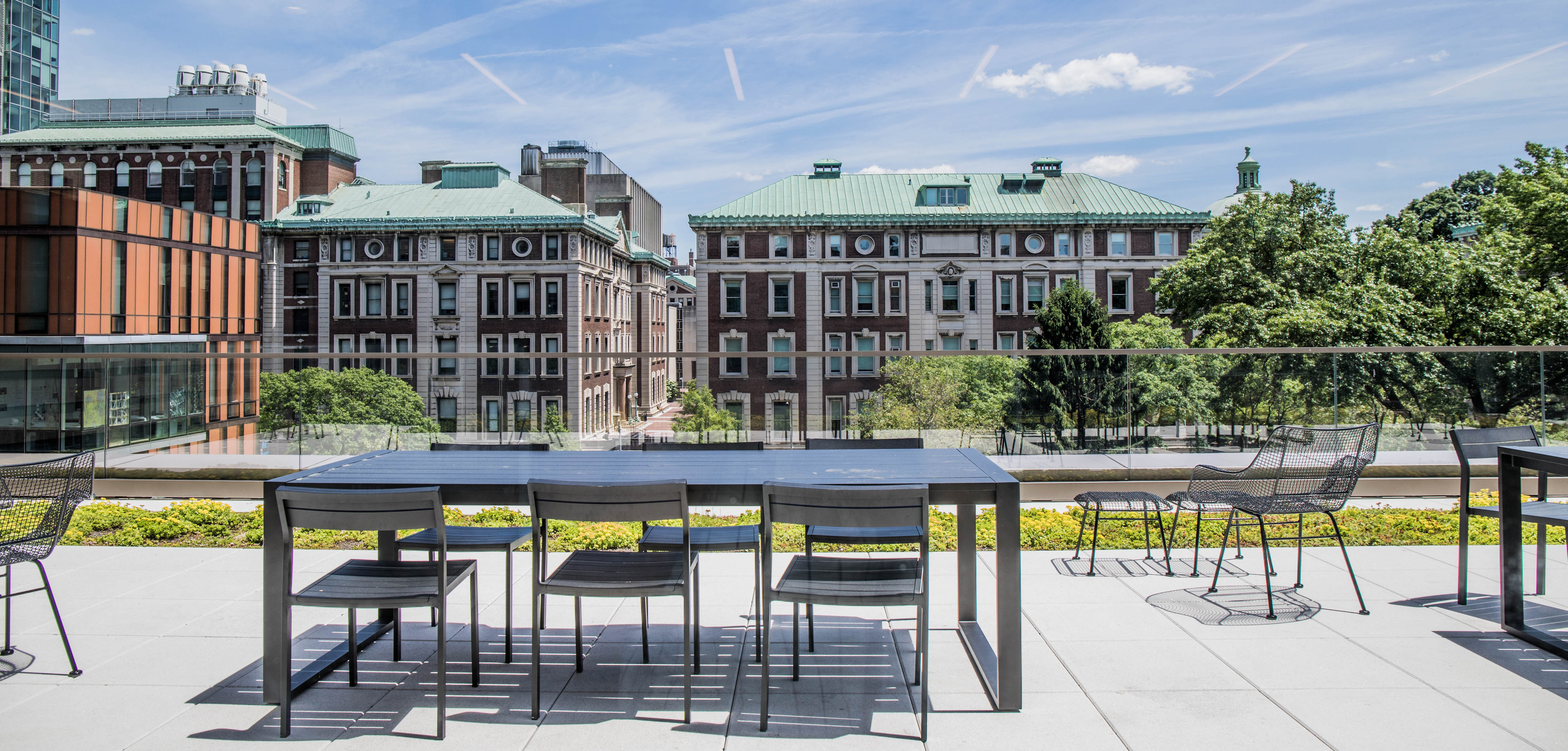 Table and chairs on terrace with Columbia campus in the background