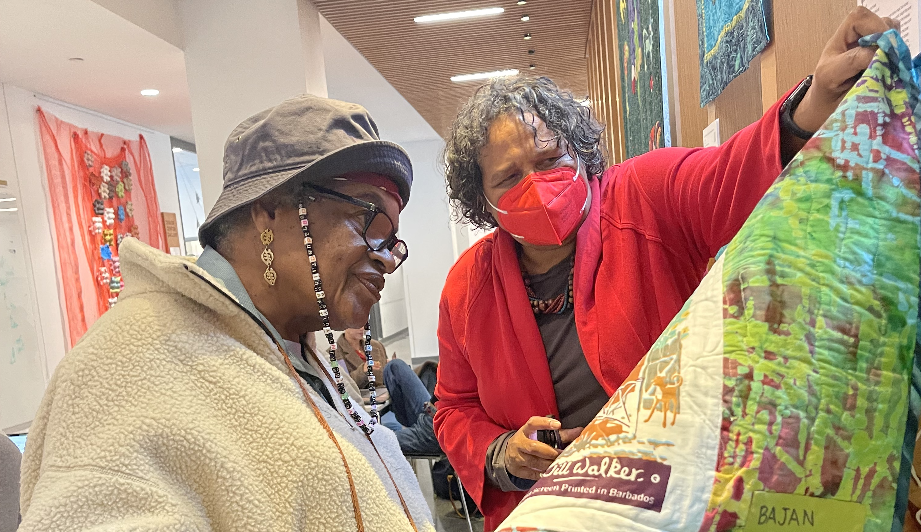 Artsts Kim F Hall and Dindga McCannon observe a quilt