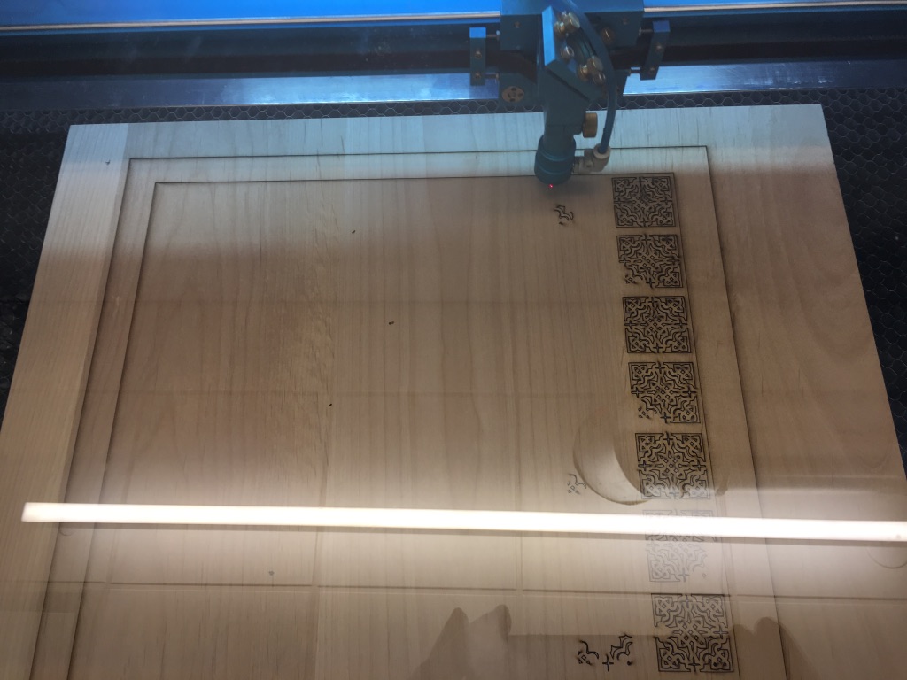 The chess board in the process of being cut by the laser cutter. 