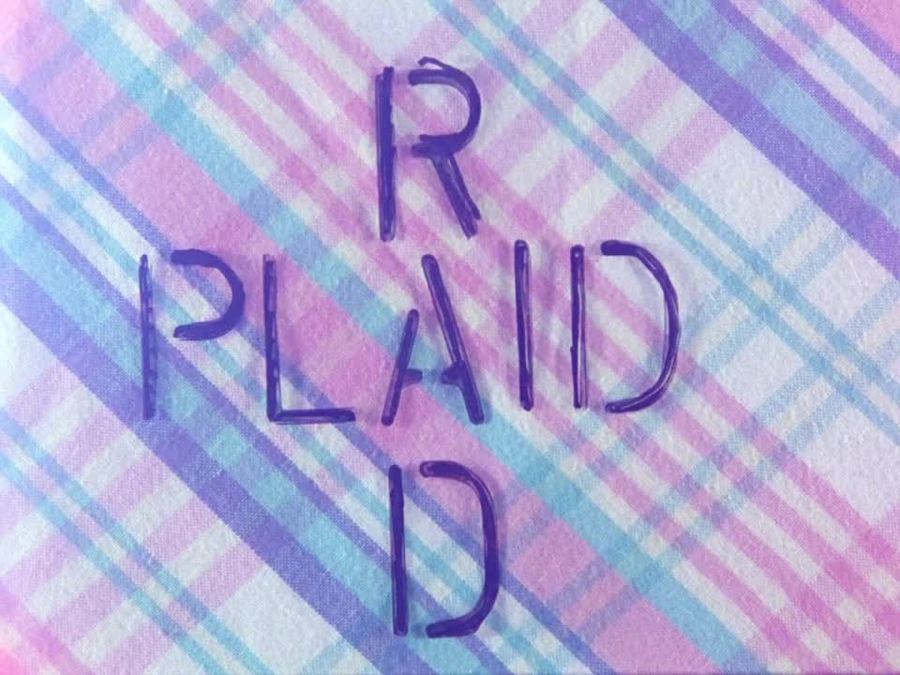 Still from Rad Plaid: "Rad" and "Plaid" written in purple capitals, crossed at the A on a plaid background.