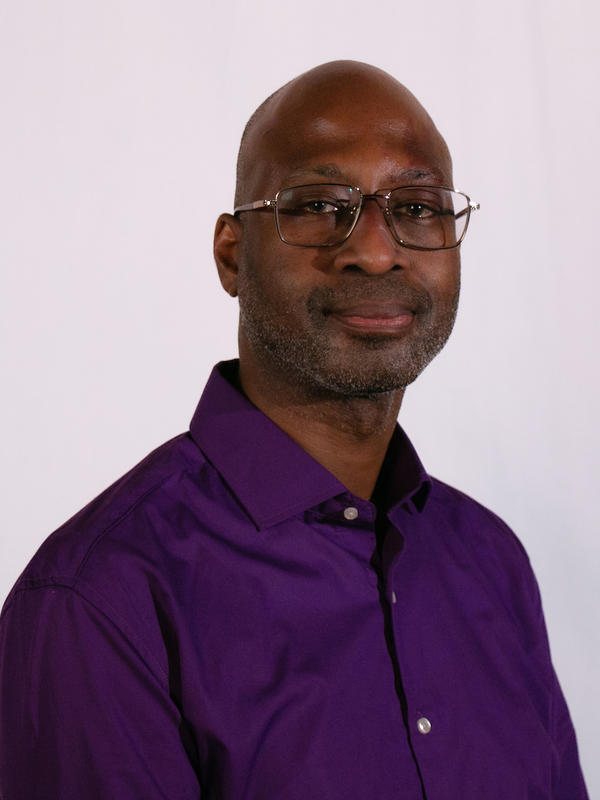 Man wearing glasses and a purple shirt