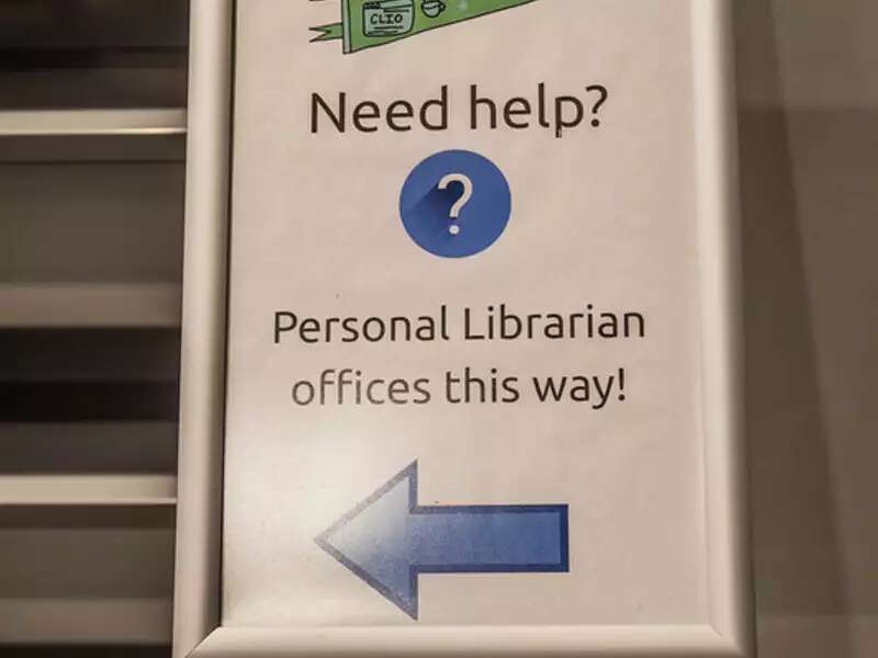 Sign reading "Need help? Personal librarians office this way!" with an arrow pointing to the left