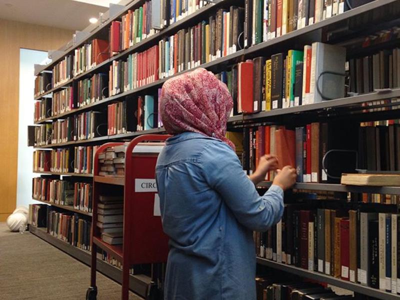student employee shelving books