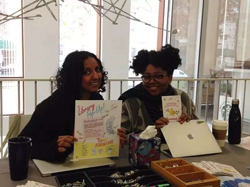 Librarians hosting a "pop up" table in the Diana Center