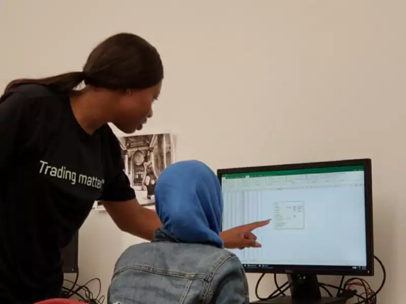 Student fellow helping another student with Excel